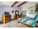 Light-filled main bedroom with beamed ceiling and an abundance of dresser and cabinet storage at 7300 W Stetson Pl # 46, Littleton, CO 80123