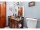 Stylish powder room with brown granite countertop, vessel sink, mosaic tile, and wood cabinets at 7300 W Stetson Pl # 46, Littleton, CO 80123