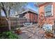 Charming backyard with a brick patio, seating area, and mature landscaping at 328 S Lincoln St, Denver, CO 80209