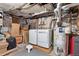 Basement laundry area with washer, dryer, water heater, and storage boxes at 328 S Lincoln St, Denver, CO 80209