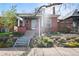 Quaint brick home with a tidy front yard, inviting porch, and mature trees in a desirable neighborhood at 328 S Lincoln St, Denver, CO 80209