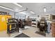 A converted garage space featuring high ceilings, multiple lighting fixtures and several pieces of printing equipment at 328 S Lincoln St, Denver, CO 80209