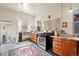 Charming kitchen with stainless steel appliances, wood cabinets, and a vintage-style rug at 328 S Lincoln St, Denver, CO 80209