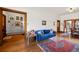 Bright living room with hardwood floors, blue sofa, and large windows at 328 S Lincoln St, Denver, CO 80209