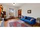 Bright living room featuring hardwood floors, a blue sofa, and natural light at 328 S Lincoln St, Denver, CO 80209