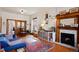 Cozy living room with fireplace, hardwood floors, and a comfortable blue sofa at 328 S Lincoln St, Denver, CO 80209