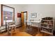 Well-lit office space featuring hardwood floors, a large window, and ample desk space at 328 S Lincoln St, Denver, CO 80209