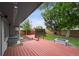 Outdoor deck showcasing a fire pit and lush green backyard surrounded by privacy fence at 3930 S Hazel Ct, Englewood, CO 80110