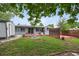Well-maintained backyard features a fire pit, large deck, and storage shed at 3930 S Hazel Ct, Englewood, CO 80110