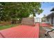 Large backyard with wood deck, storage shed, and privacy fence at 3930 S Hazel Ct, Englewood, CO 80110