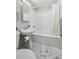 Cozy bathroom featuring a pedestal sink, large mirror, and white tub with shower at 3930 S Hazel Ct, Englewood, CO 80110