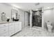 Modern bathroom featuring sleek marble floors, a vessel sink, and a glass-enclosed shower at 3930 S Hazel Ct, Englewood, CO 80110