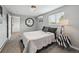 Cozy bedroom featuring neutral tones, a decorative mirror, and an air conditioning unit at 3930 S Hazel Ct, Englewood, CO 80110