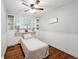 Inviting bedroom with built-in shelves, a ceiling fan, and warm wood flooring at 3930 S Hazel Ct, Englewood, CO 80110