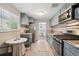 Efficient kitchen with stainless steel appliances, granite countertops, and a breakfast nook by the window at 3930 S Hazel Ct, Englewood, CO 80110