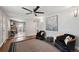 Open concept living area with hardwood floors, black arm chairs, a ceiling fan, and seamless access to kitchen at 3930 S Hazel Ct, Englewood, CO 80110