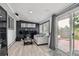 Stylish living room featuring a black accent wall and sliding glass doors to the patio at 3930 S Hazel Ct, Englewood, CO 80110