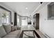 Spacious living room with hardwood floors, comfortable seating, and natural light at 3930 S Hazel Ct, Englewood, CO 80110