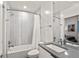 Modern bathroom featuring a shower-tub combination, sleek vanity, and neutral tiling at 3612 Wyandot St, Denver, CO 80211
