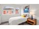 Well-lit bedroom with a twin bed, sleek nightstand, and modern artwork at 3612 Wyandot St, Denver, CO 80211