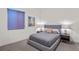Cozy bedroom with a plush bed, stylish nightstands, and a modern window shade at 3612 Wyandot St, Denver, CO 80211
