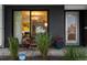 Inviting front porch with seating and lush greenery offers a warm welcome to this modern home at 3612 Wyandot St, Denver, CO 80211