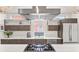 Bright, modern kitchen with stainless steel appliances, large island, and hardwood floors at 3612 Wyandot St, Denver, CO 80211