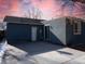 A backyard with a concrete patio, a fenced perimeter, and a blue house at 5344 Wheeling St, Denver, CO 80239