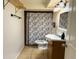 Cozy bathroom featuring tile flooring, shower curtain, and a wooden vanity at 5344 Wheeling St, Denver, CO 80239