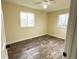 Bright bedroom featuring hardwood floors, neutral walls, and two windows at 5344 Wheeling St, Denver, CO 80239