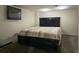 Bedroom features a large bed with wood trim, an accent wall, and dark carpet at 5344 Wheeling St, Denver, CO 80239