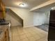 A kitchen with cabinets, granite countertops, tile floors, and stairs leading to the second floor at 5344 Wheeling St, Denver, CO 80239