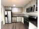 Modern kitchen features stainless steel appliances, gray cabinets, granite countertops, and a tile backsplash at 5344 Wheeling St, Denver, CO 80239