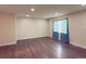 Bright living room featuring hardwood floors, neutral walls, recessed lighting, and a large window at 5344 Wheeling St, Denver, CO 80239