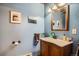 Bathroom featuring a stylish vanity, unique paint color, and decor at 17306 W 17Th Pl, Golden, CO 80401