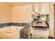 The bathroom features a tub with tiled surround and an entryway into the main bedroom at 17306 W 17Th Pl, Golden, CO 80401