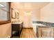 Bright bathroom with double vanity, tub, and wood-look flooring at 17306 W 17Th Pl, Golden, CO 80401