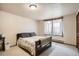 Comfortable bedroom featuring neutral walls, carpet floors, and a window with natural light at 17306 W 17Th Pl, Golden, CO 80401