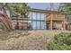 Back exterior view of this property, showing glass walls, patios and outdoor space at 17306 W 17Th Pl, Golden, CO 80401