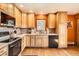 A well-lit kitchen with wooden cabinets and stainless steel appliances offers style and functionality at 17306 W 17Th Pl, Golden, CO 80401