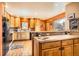 Warm kitchen features wooden cabinets, hard wood flooring, and plenty of natural light at 17306 W 17Th Pl, Golden, CO 80401