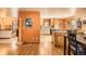 Open concept kitchen with orange walls, wooden cabinets, and hardwood floors at 17306 W 17Th Pl, Golden, CO 80401