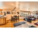 Living room features hardwood floors, stone fireplace, a large window and comfortable seating at 17306 W 17Th Pl, Golden, CO 80401