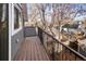 Outdoor wooden balcony offering neighborhood views, framed by a sturdy black metal railing at 3142 W 26Th Ave, Denver, CO 80211
