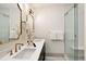 Contemporary bathroom featuring double sinks, gold hardware, and a glass-enclosed shower at 3142 W 26Th Ave, Denver, CO 80211