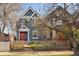 Charming two-story home with a red door, complemented by a brick walkway and white picket fence at 3142 W 26Th Ave, Denver, CO 80211