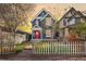 Charming two-story home with blue siding, white trim, a red door and a lovely landscaped yard at 3142 W 26Th Ave, Denver, CO 80211