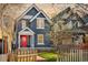 Charming two-story home with blue siding, white trim, a red door and a lovely landscaped yard at 3142 W 26Th Ave, Denver, CO 80211