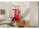 Welcoming foyer with a striking red front door, hardwood floors, and a staircase at 3142 W 26Th Ave, Denver, CO 80211