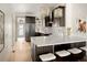 Modern kitchen with dark cabinetry, a white quartz countertop, and stylish bar stool seating at 3142 W 26Th Ave, Denver, CO 80211